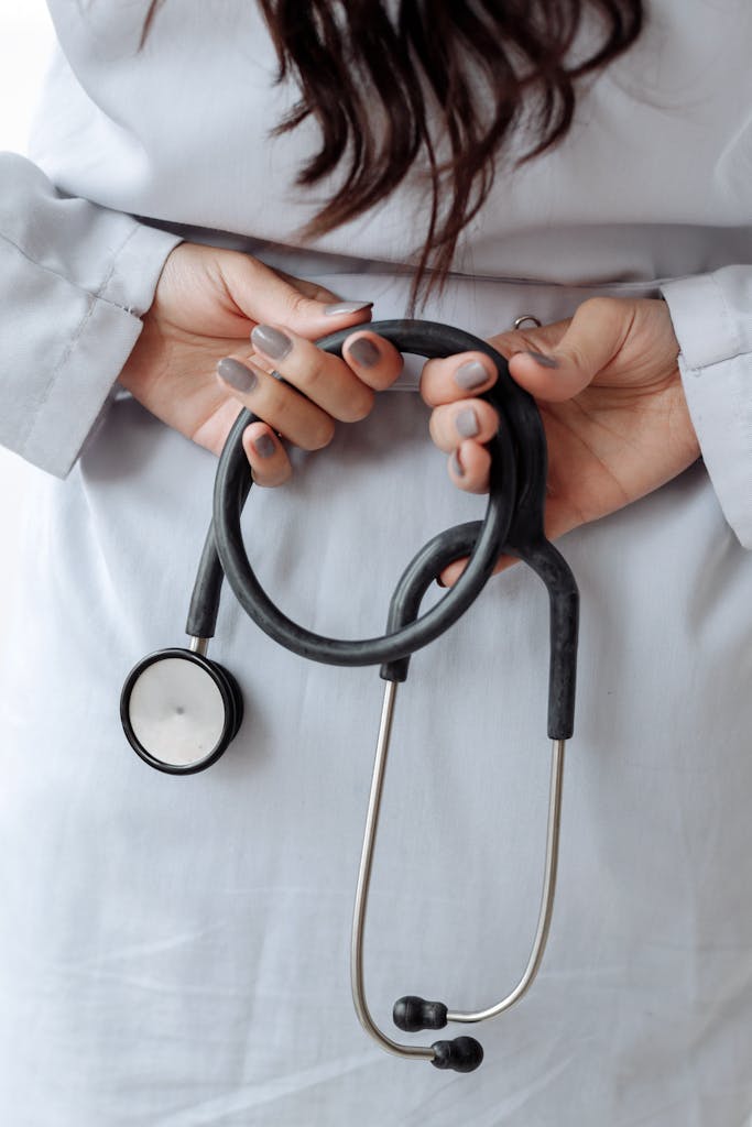 Hands with Gray Nail Polish on Her Fingers while Holding Stethoscope